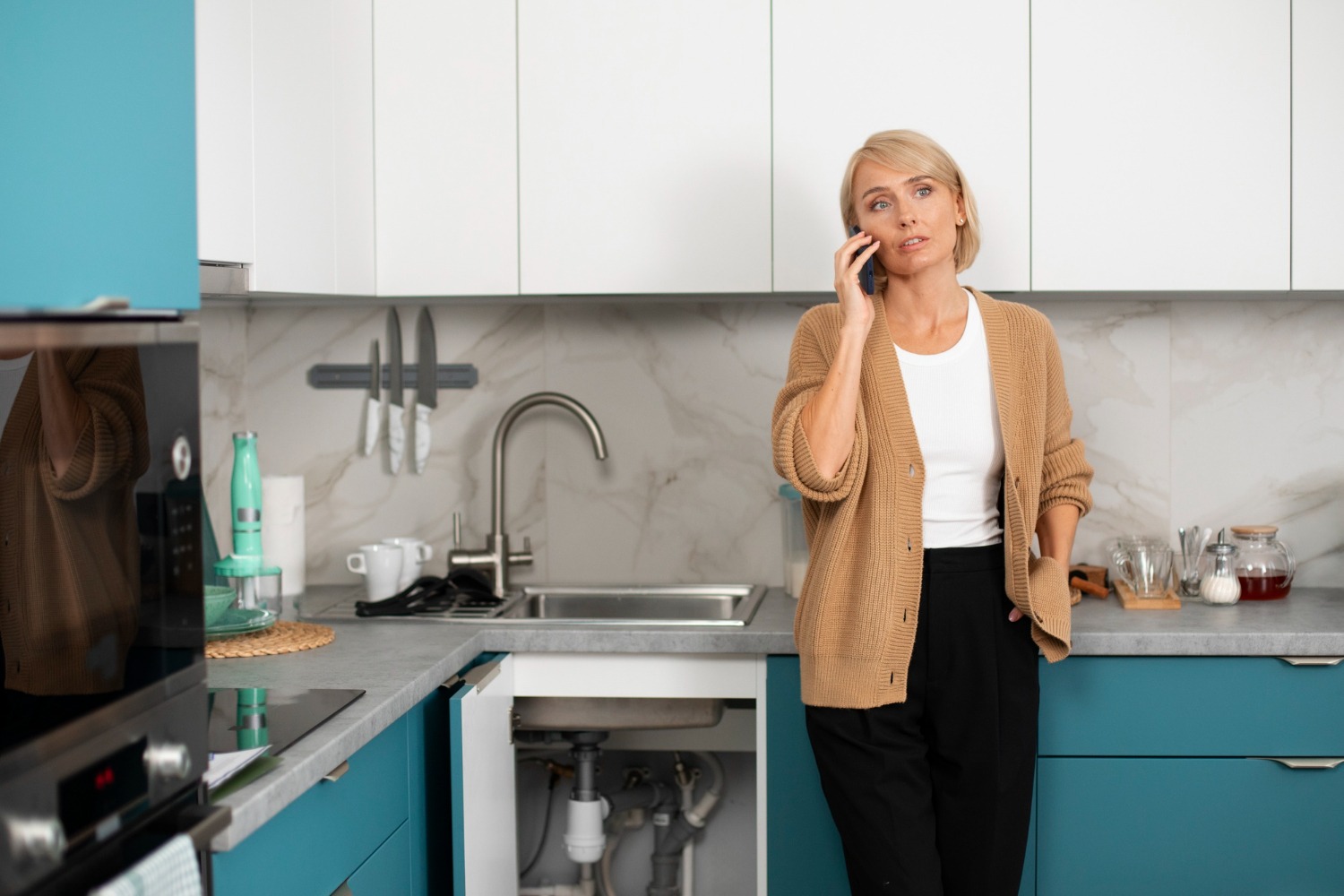 Homeowner in kitchen benefiting from softened water